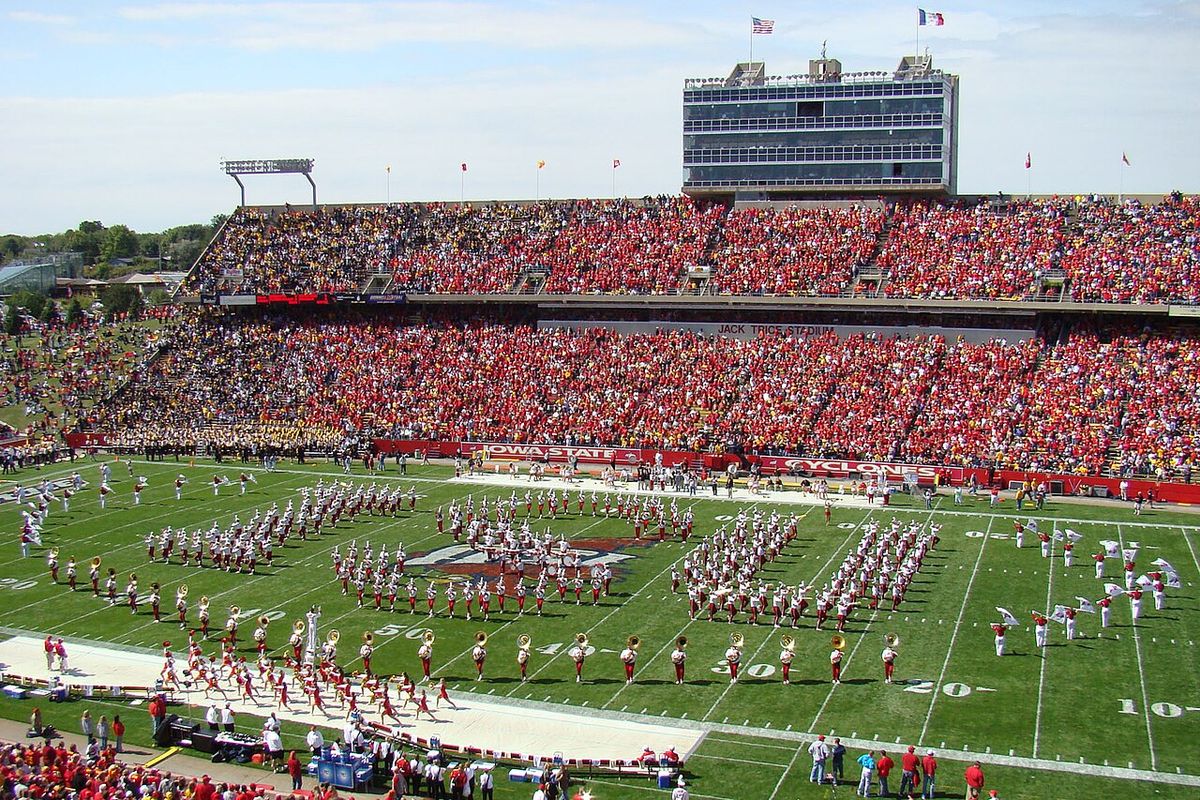 Iowa State's marching band spells ISU on the field at a packed Jack Trice Stadium on a sunny day.