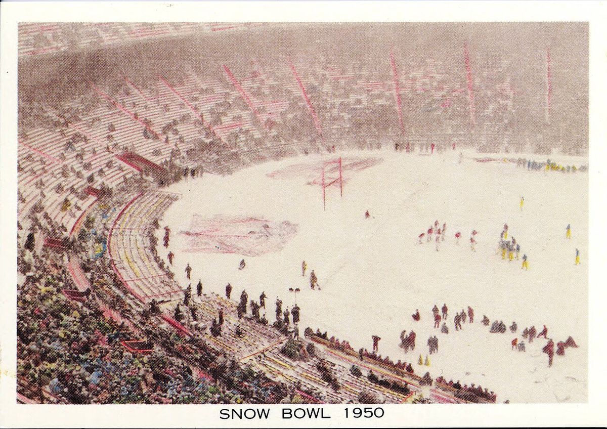 A vintage postcard of Ohio Stadium covered in snow, with players scattered across a white field and the words Snow Bowl 1950.