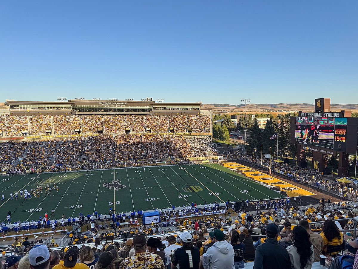 A sunny afternoon view of a packed War Memorial Stadium in Laramie, Wyoming, from high in the stands.